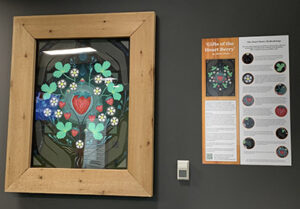 The Gifts of the Heart Berry: painting and information poster hanging in place.